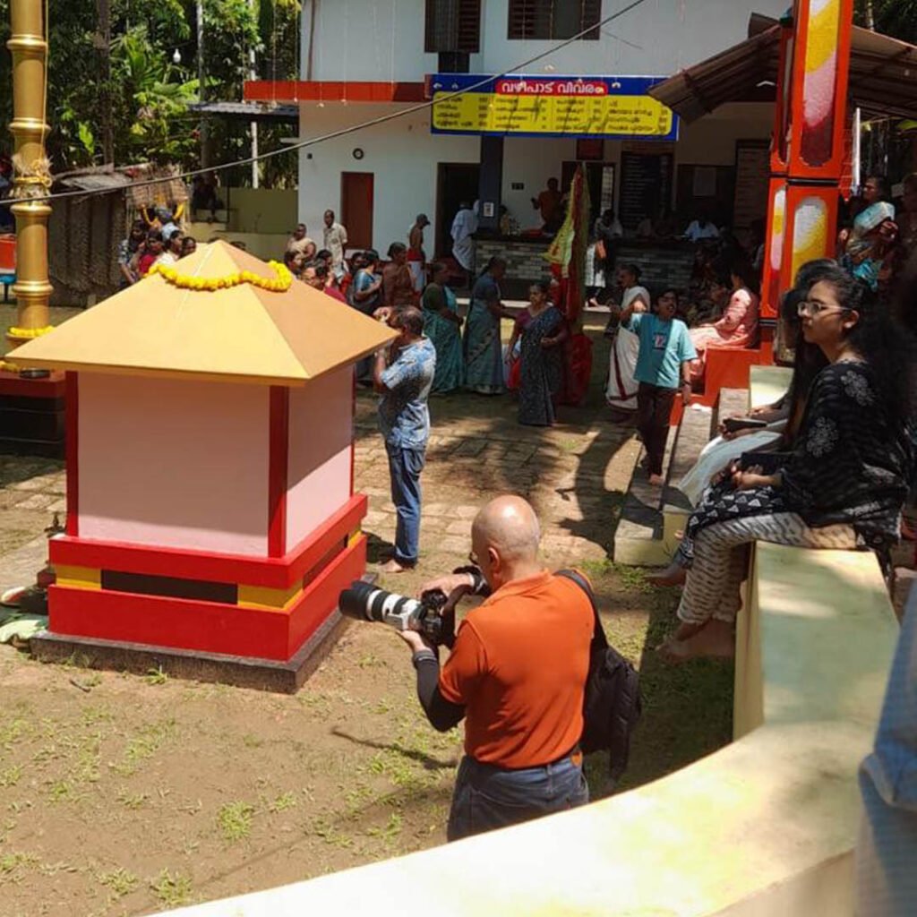 Photographer Sasheel Mures capturing scenes at Palayi Sree Porkali Bhagavathy Kaavu during a Kandakarnan Theyyam festival in Kannur, Kerala.