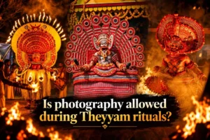 Three Theyyam performers in fire-lit ritual costume at a Kerala temple, illustrating whether photography is allowed during Theyyam