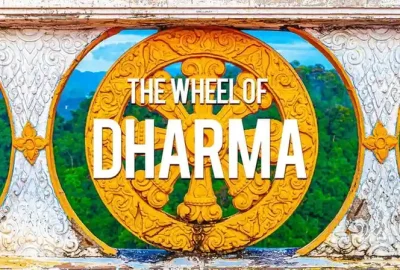 Golden Wheel of Dharma with ornate carvings, framed by a decorative arch, set against green hills and blue sky, with the text The Wheel of Dharma.